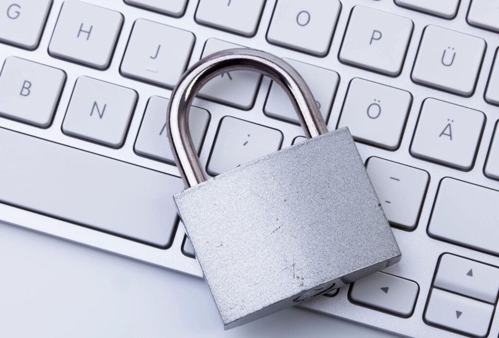 Silver padlock resting on a computer keyboard, illustrating small business cybersecurity