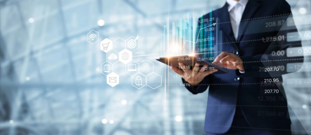 Businessman holding a tablet with floating data icons and analytics overlay, representing AI tools in business